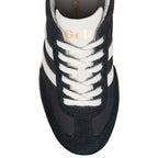 Close-up of a black Gola trainer with white laces and white stripes on the side
