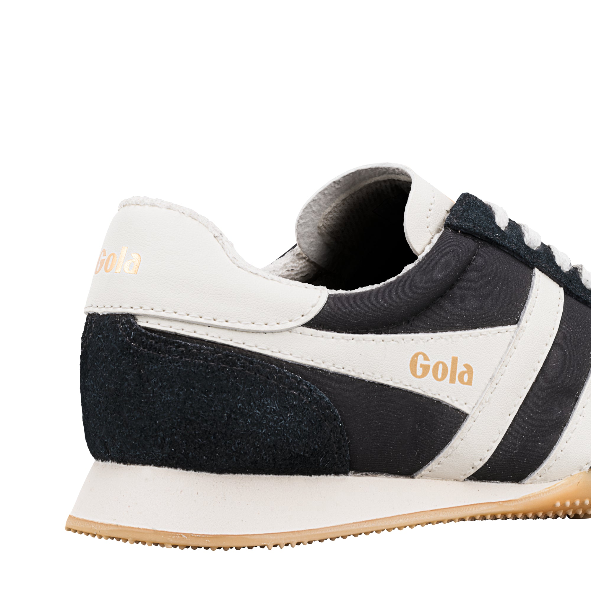 Close-up of the heel of a black and white Gola trainer with a gum sole