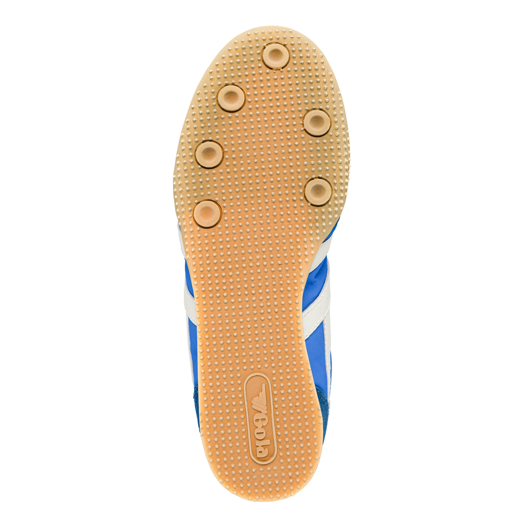 Underside of a blue and white Gola trainer with a beige sole and six circular grips