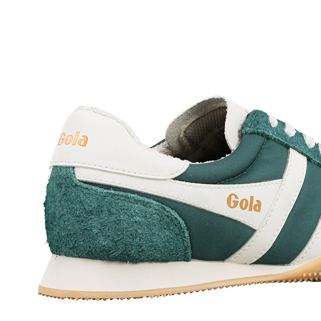 Rear view of a green and white Gola trainer with suede detailing and gum sole