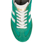 Top-down view of a green Gola trainer with white laces and white stripes