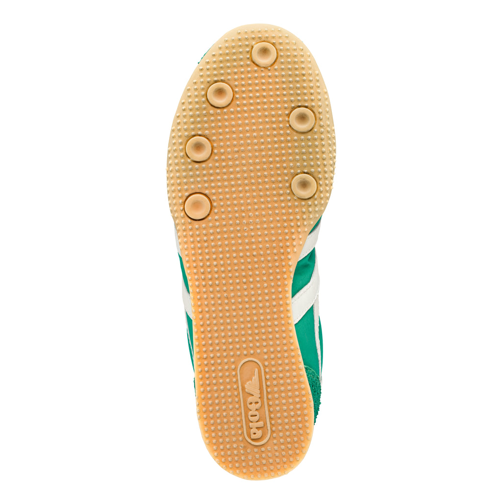 Underside of a green and white trainer with a tan sole and Gola branding