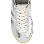 Close-up of a silver Gola trainer with white laces and stripes