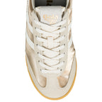 Close up of a gold and off-white Gola trainer with white laces and a gum sole