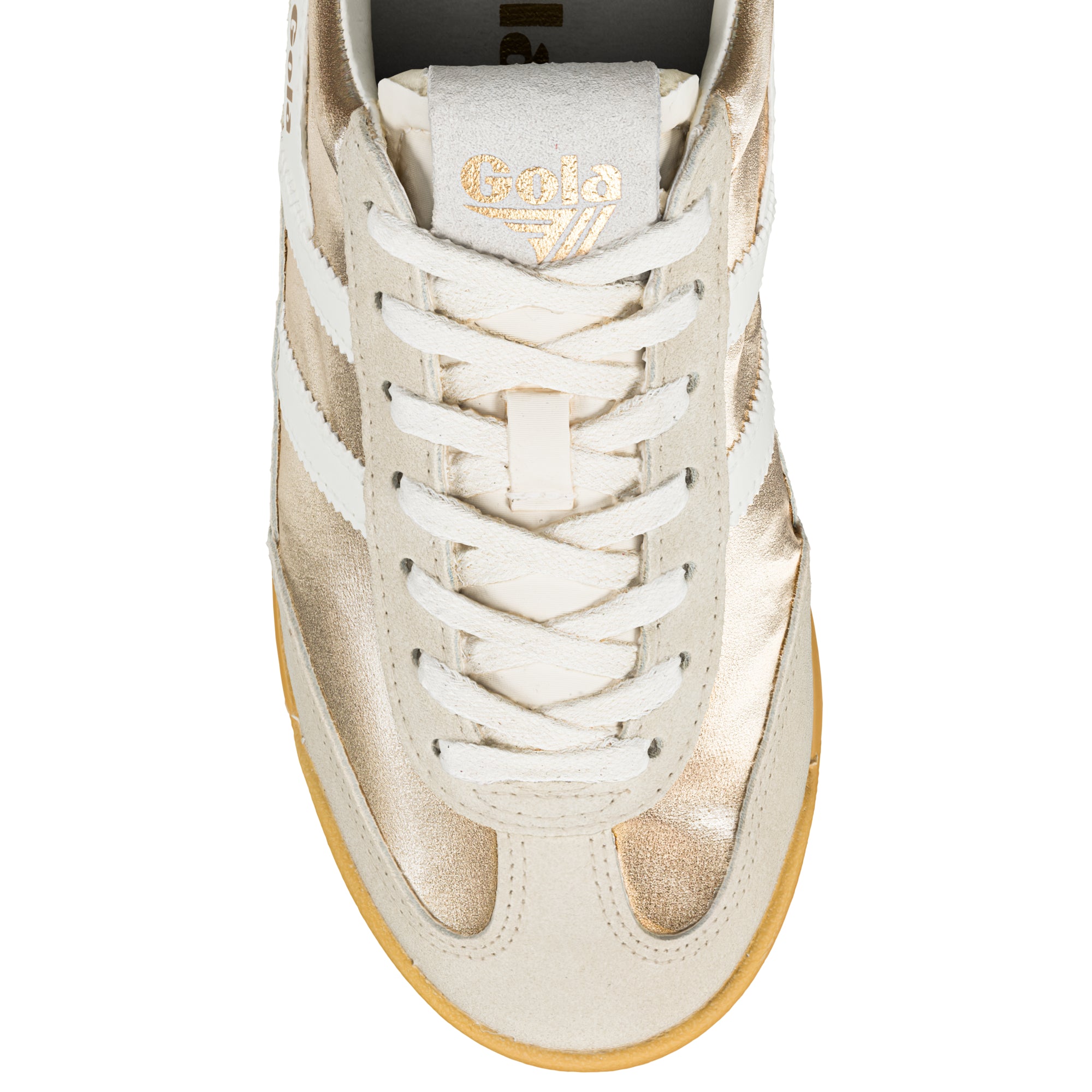 Close up of a gold and off-white Gola trainer with white laces and a gum sole