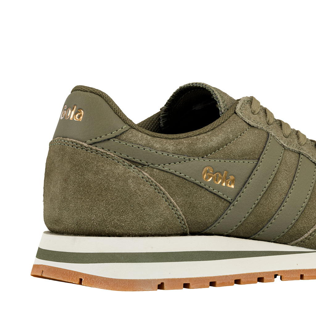 Olive green suede trainer with gold Gola branding and a white and gum rubber sole