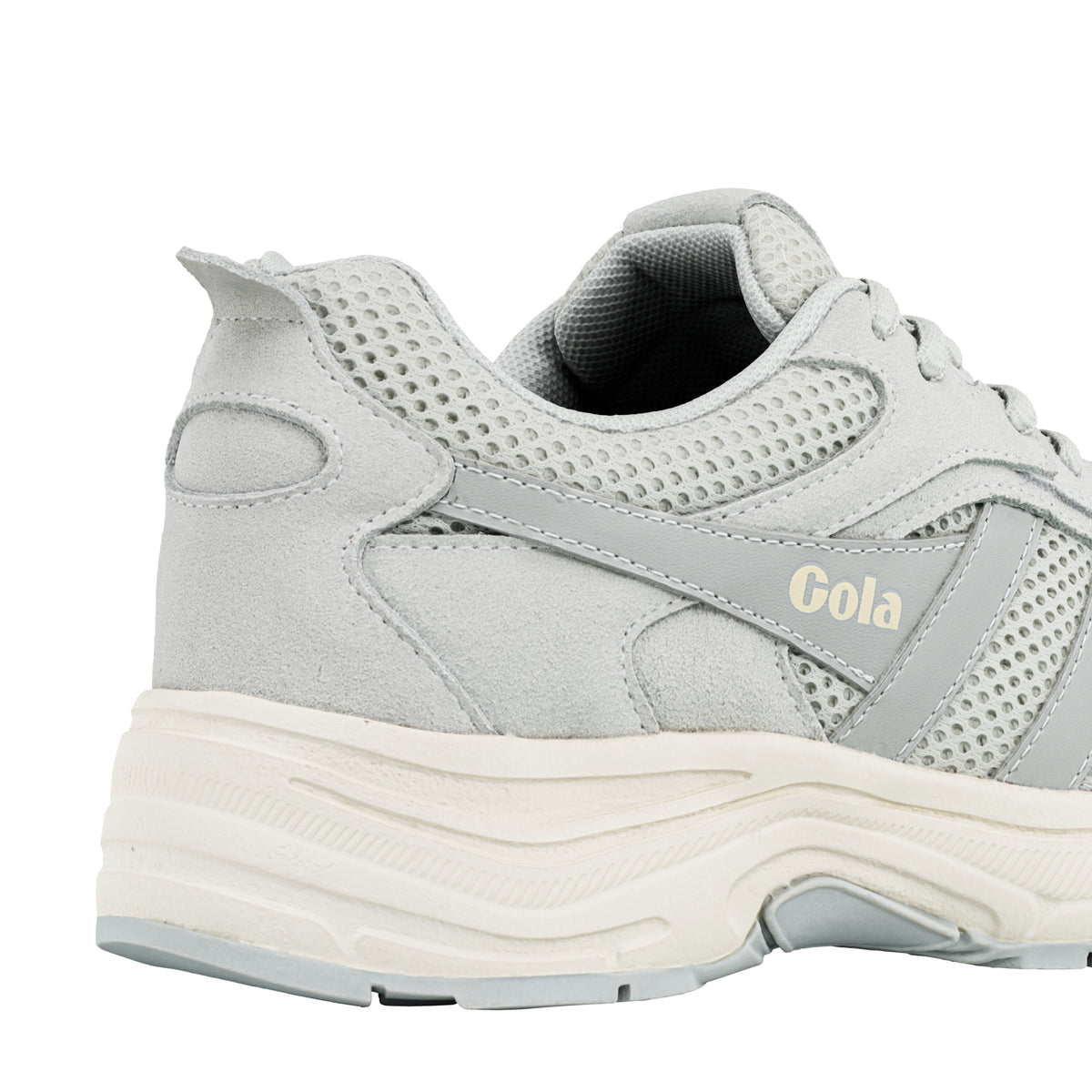 Close up of the heel and side panel of a light grey Gola trainer with mesh detailing and a cream sole
