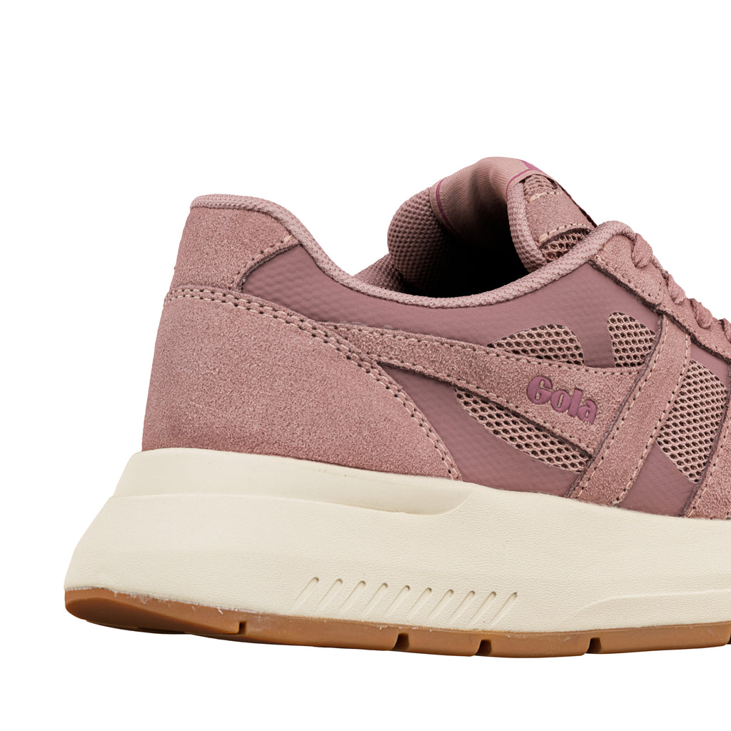 Close up of the heel and side of a dusty pink Gola trainer with a cream midsole and gum rubber sole
