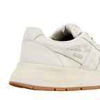 Close up of the heel and side panel of a cream coloured Gola trainer with mesh detailing and a gum rubber sole