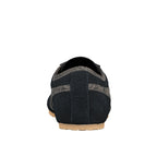 Rear view of a navy blue suede trainer with grey textured detailing and a gum rubber sole