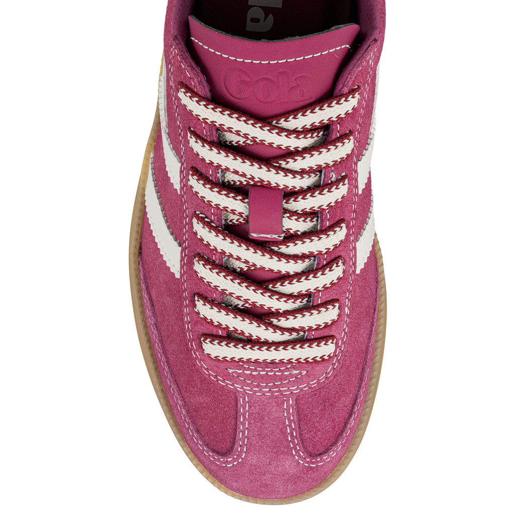 Top view of a pink suede Gola trainer with white striped detailing and patterned laces