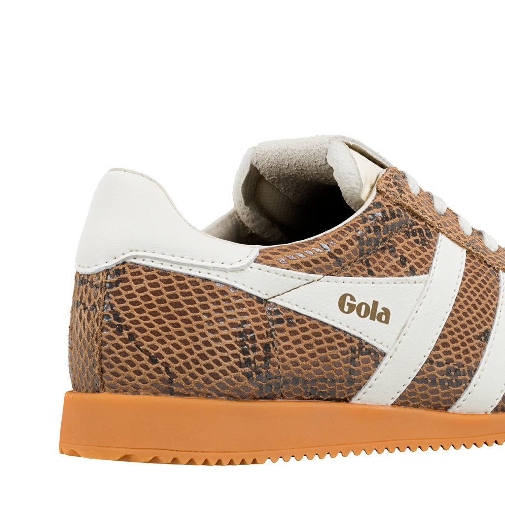 Close up of a brown snakeskin pattern Gola trainer with white trim and a gum sole