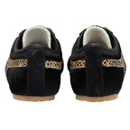 Pair of black pony hair trainers with leopard print stripe, rear view