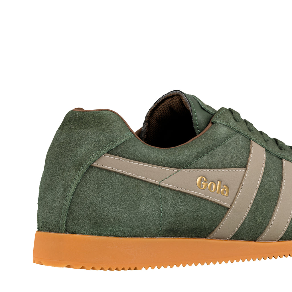 Close up of the heel and side of a green suede Gola trainer with a tan gum sole