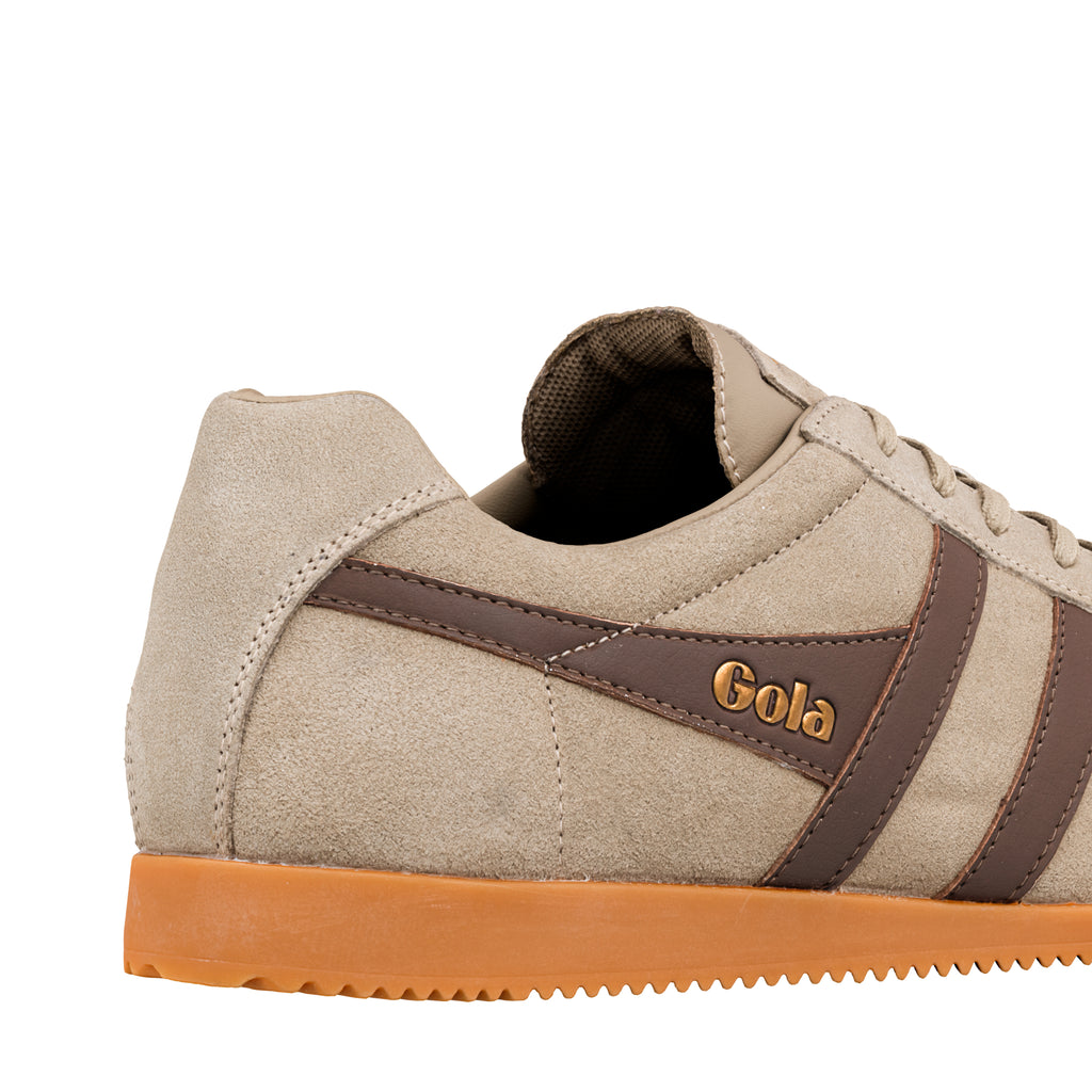 Close up of beige suede Gola trainer with brown side stripes and gum sole