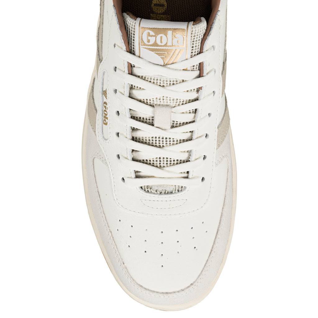 Top view of a white Gola trainer with lace up fastening and gold branding on the tongue