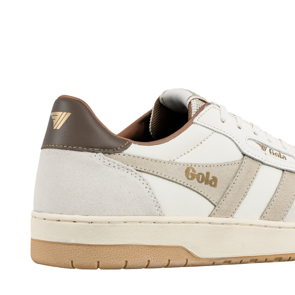 Close up of the heel and side panel of a white and beige Gola trainer with a gum rubber sole