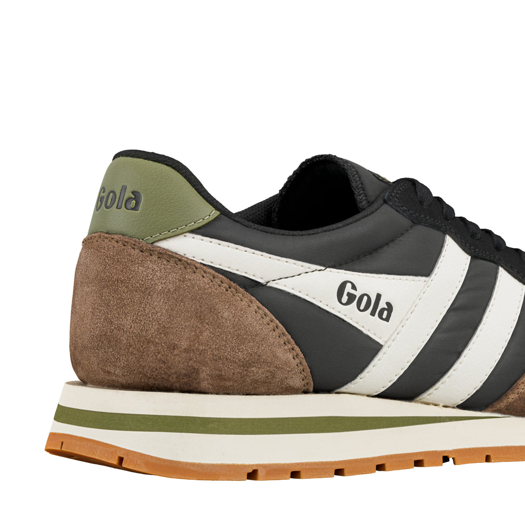 Close up of the heel and side of a black and brown Gola trainer with white side stripes and a gum sole