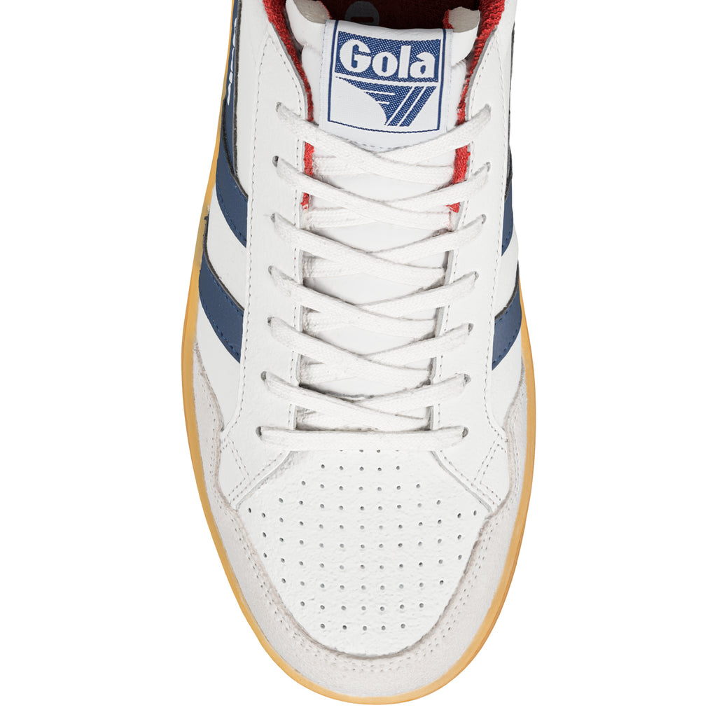 Close-up of a white Gola trainer with blue stripes, red lining, and white laces