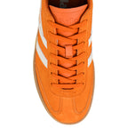 Top view of an orange suede Gola trainer with white side stripes and a gum sole