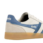 Close up of the heel and side panel of a white and blue Gola trainer with a gum sole