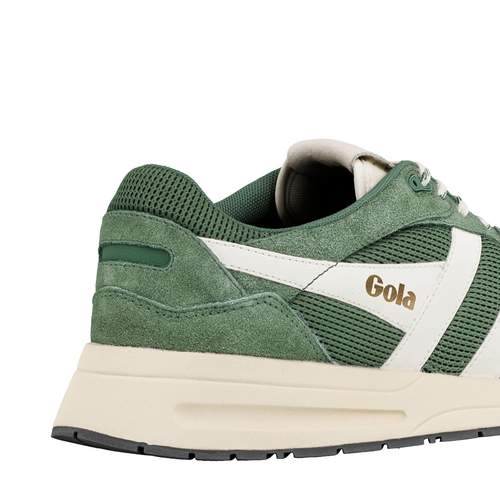 Close up of the heel and side of a green and cream Gola trainer
