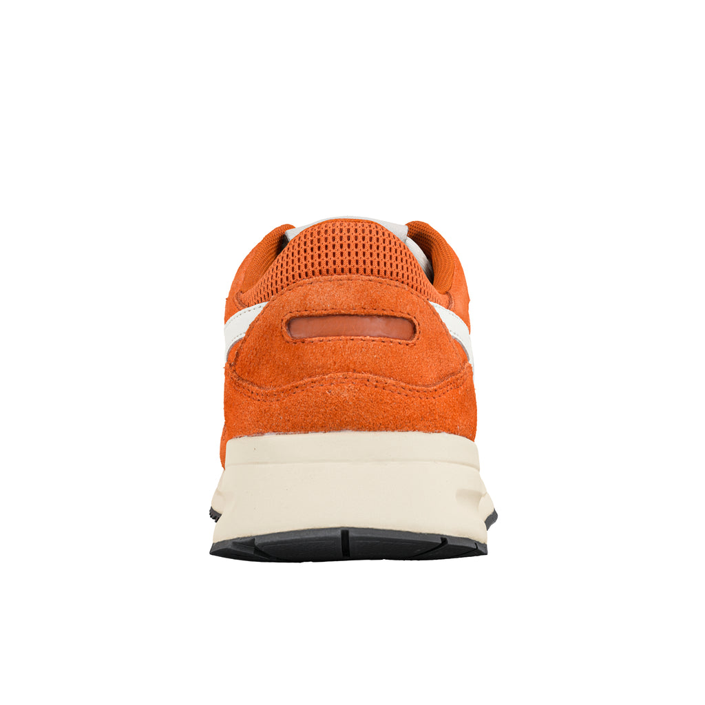 Rear view of an orange suede trainer with a cream midsole and black rubber sole