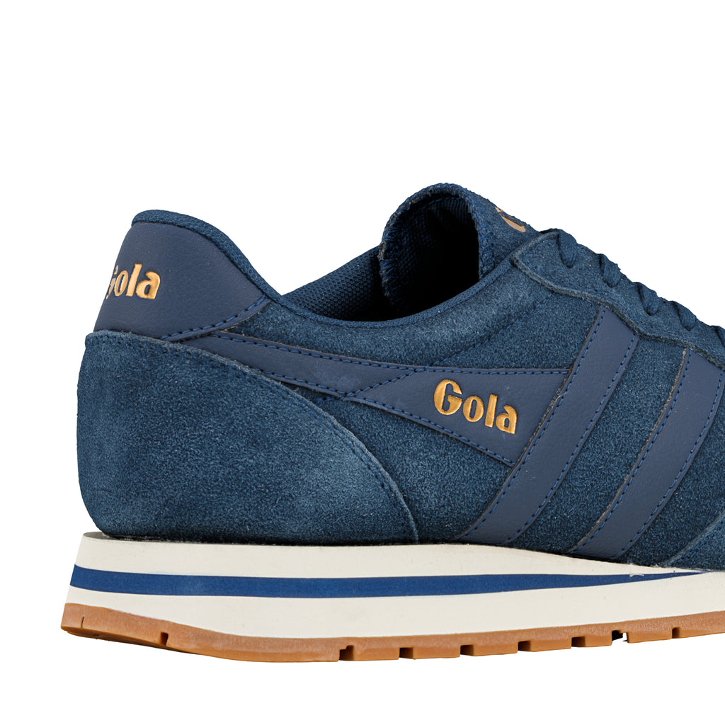 Rear view of a navy blue suede Gola trainer with a white midsole and gum rubber sole