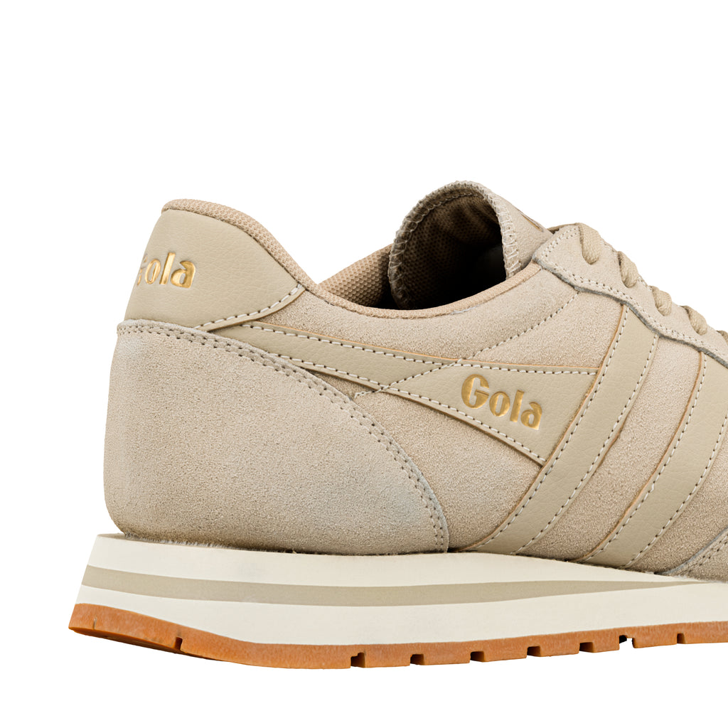 Beige suede Gola trainer with gold branding on the heel and side panel
