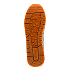 Orange rubber trainer sole with triangular tread pattern and Gola branding