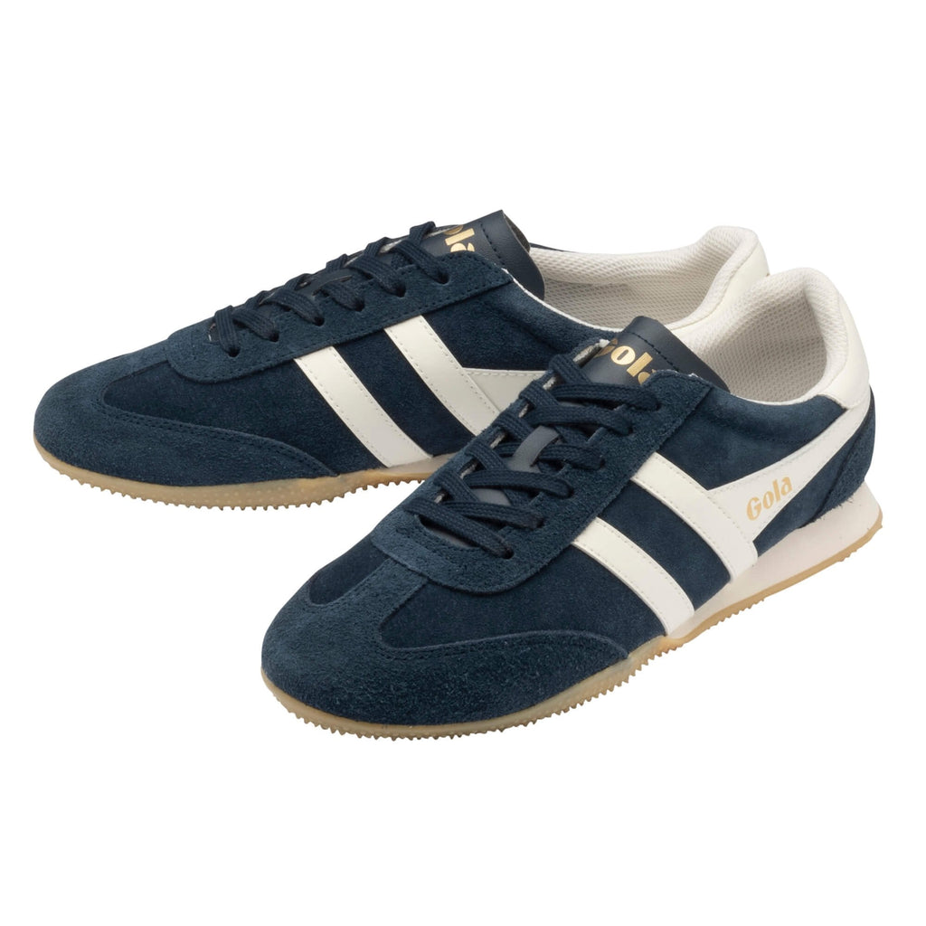 Navy blue suede trainers with white side stripes and gum soles