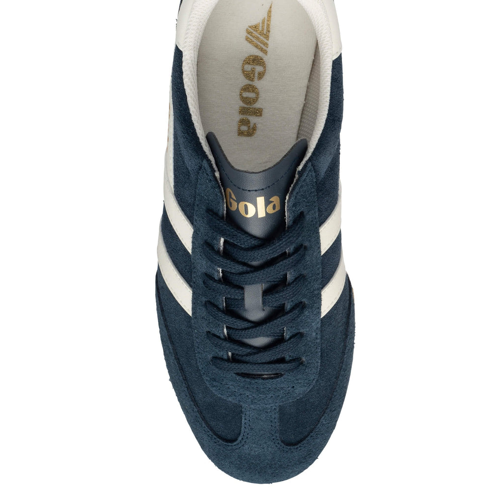 Top view of a navy blue suede Gola trainer with white side stripes and gold branding