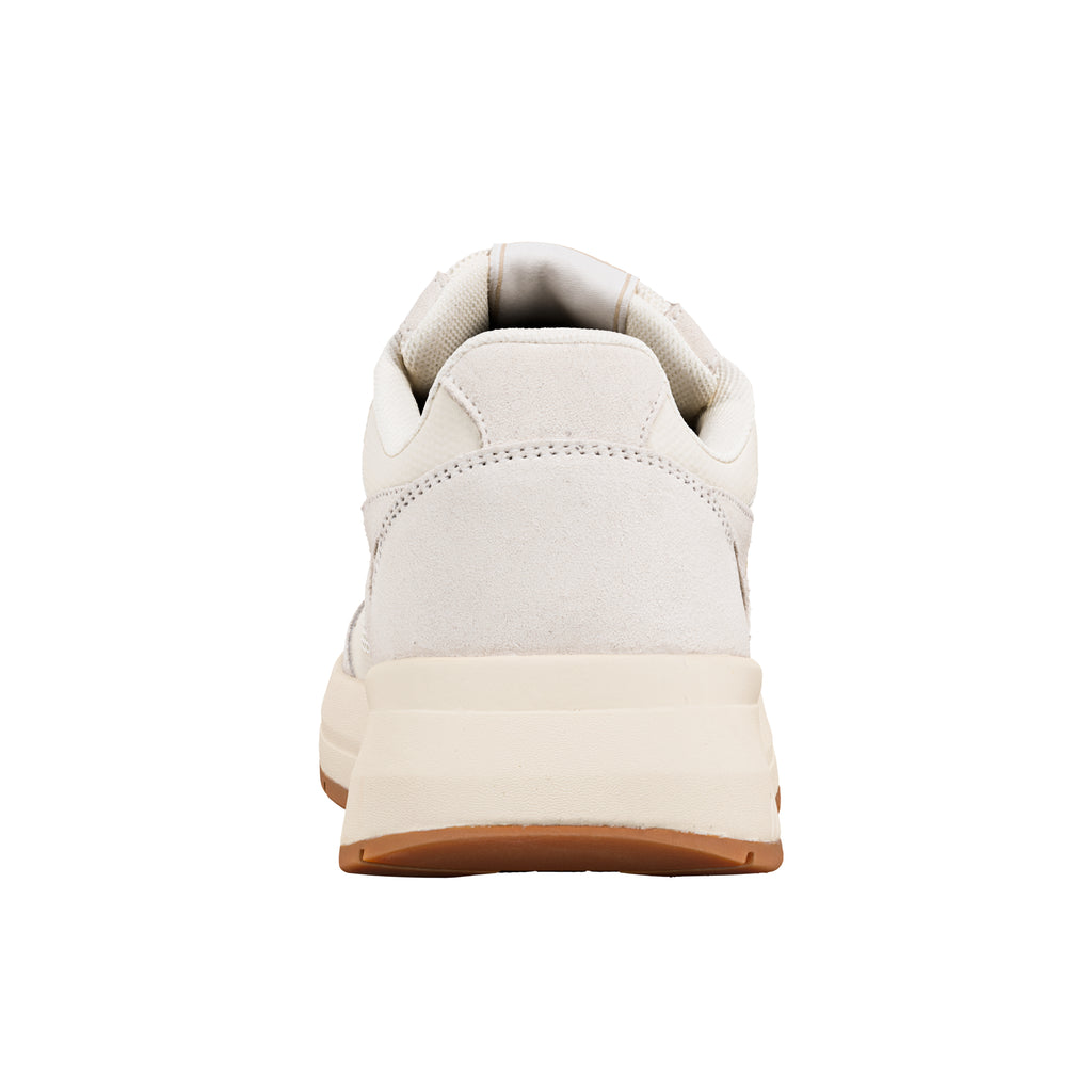 Rear view of a cream coloured suede trainer with a thick rubber sole