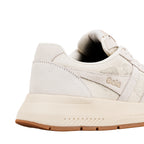 Close up of the heel and side of a cream Gola trainer with mesh panels and a gum rubber sole