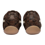 Pair of brown snakeskin pattern trainers with beige soles, rear view