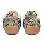 Rear view of two trainers with snakeskin pattern, green stripe, and light brown soles