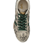 Top-down view of a Gola trainer in snakeskin print with dark green laces and side stripes
