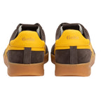 Pair of Gola trainers in brown suede with yellow heel tabs and gum soles, rear view