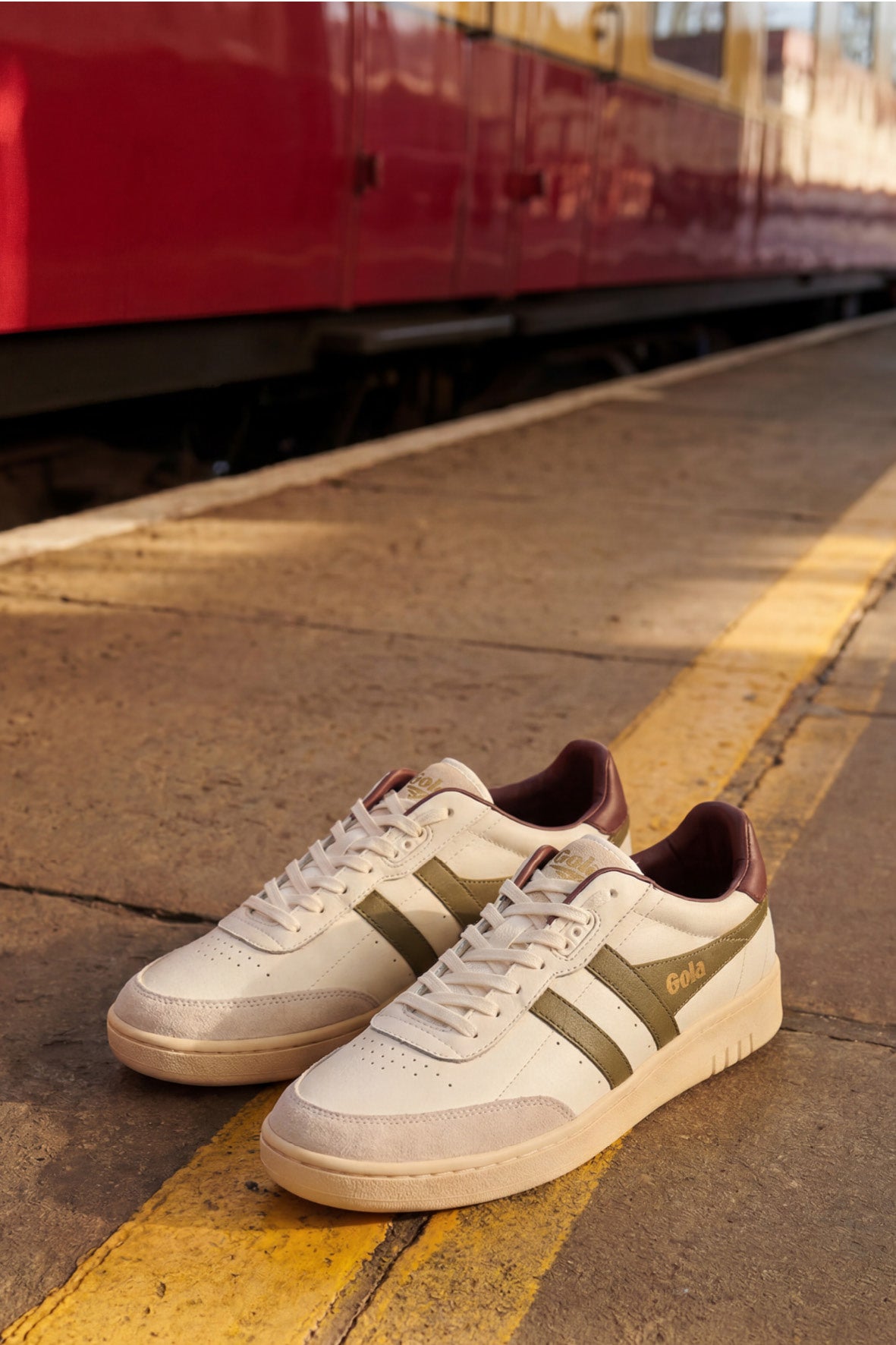 Pair of Gola trainers on a train platform