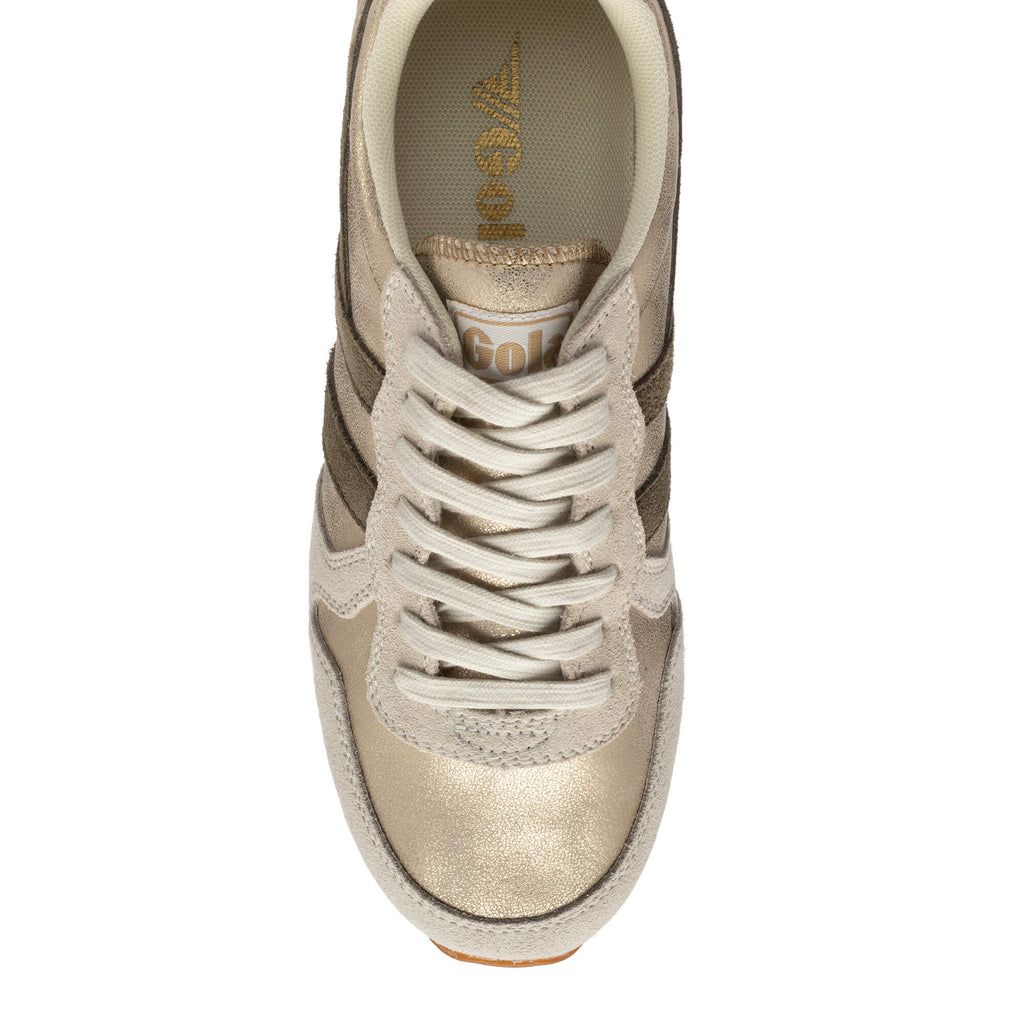 Top-down view of a gold and beige Gola trainer with white laces