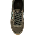 Top-down view of a khaki trainer with light green stripes and dark green laces