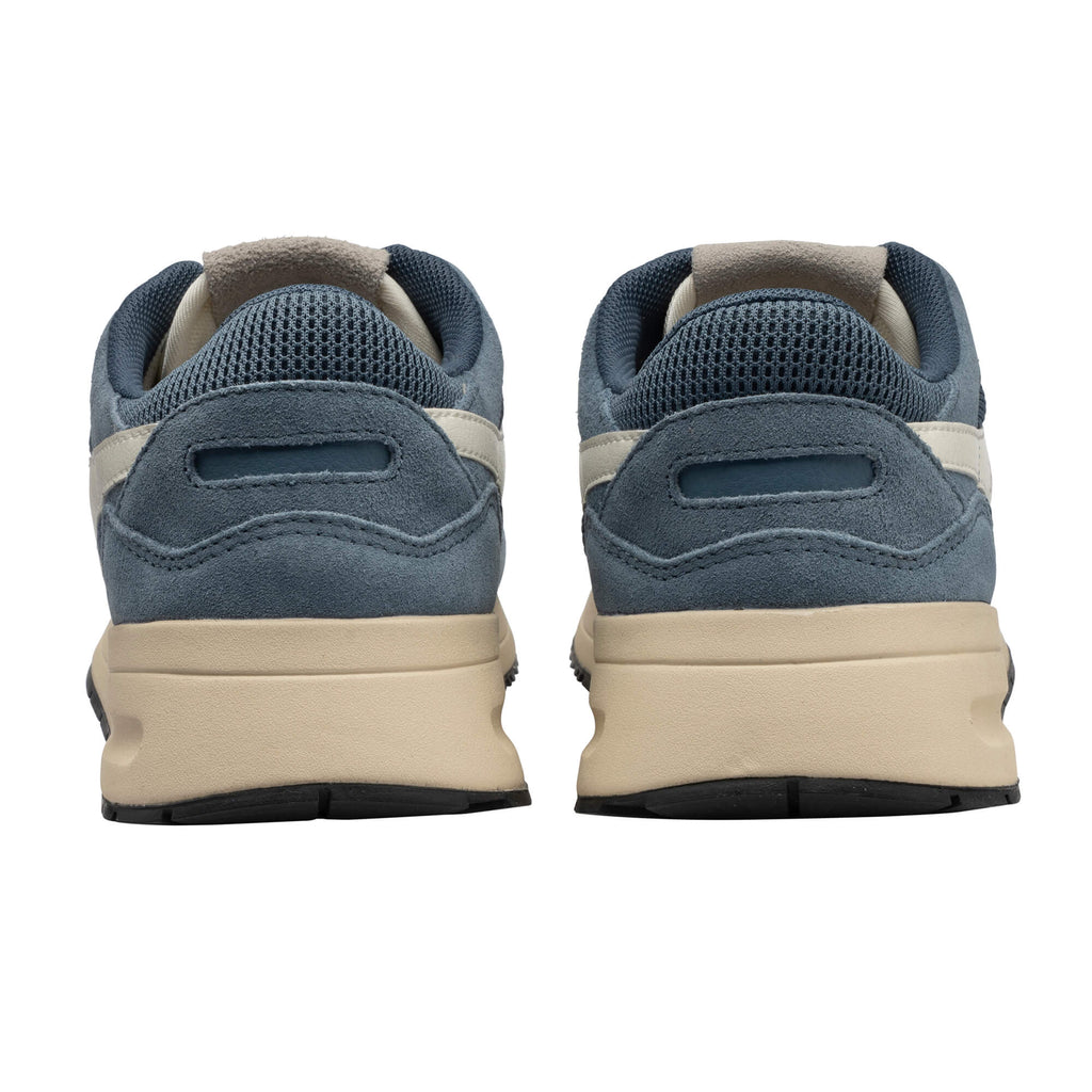 Pair of blue suede trainers with beige soles, rear view