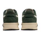 Pair of dark green and beige trainers, rear view