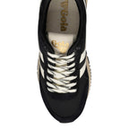 Top-down view of a black Gola trainer with cream laces and side stripes