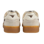 Rear view of two beige and brown trainers with gum soles
