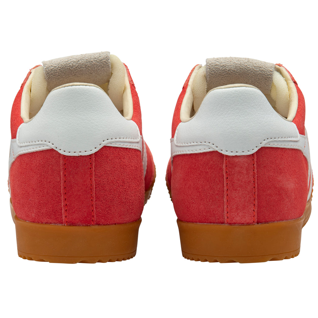 Red trainers with white soles and brown soles on a white background