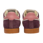 Pair of burgundy suede trainers with pink leather heel tabs and gum soles, rear view
