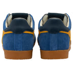 Blue and yellow trainers with brown soles on a white background