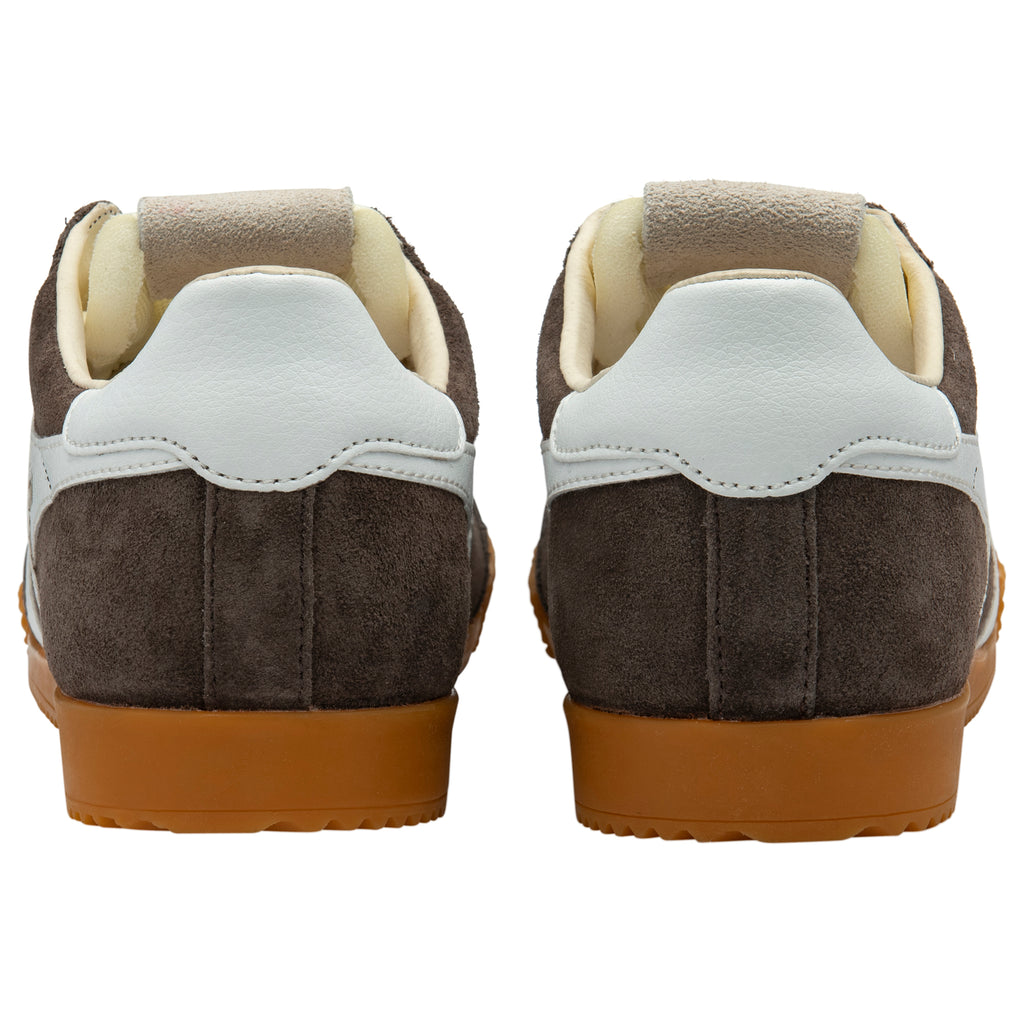 Back view of brown suede trainers with white soles on a white background