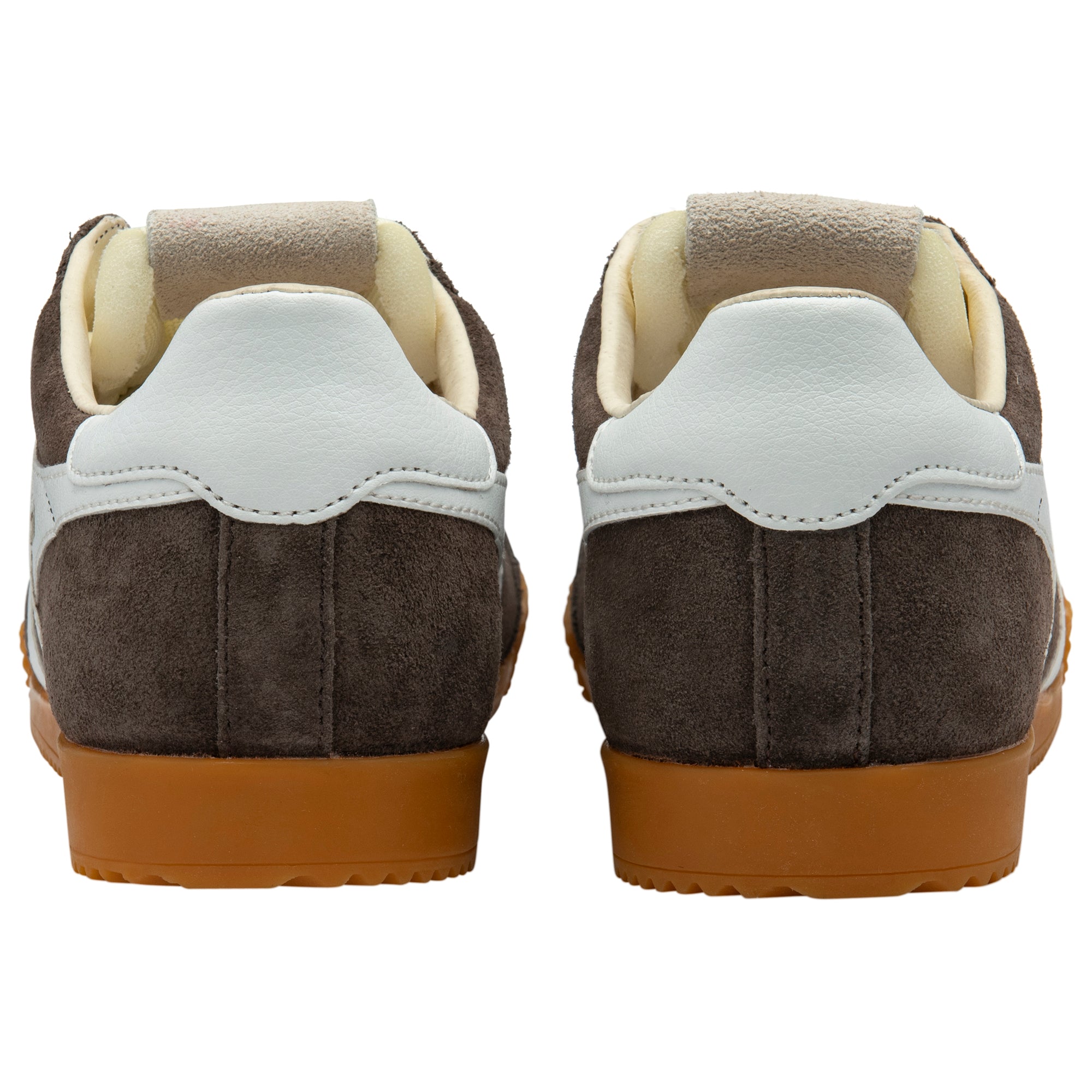 Back view of brown suede trainers with white soles on a white background